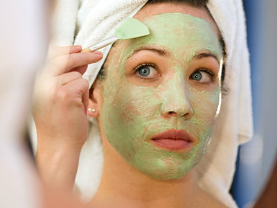 Woman applying face mask