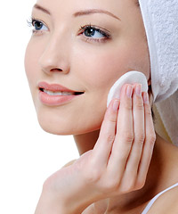 Woman applying skin toner