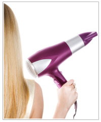 Blonde model with a blow-dryer