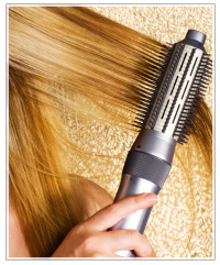 Model running brush through hair