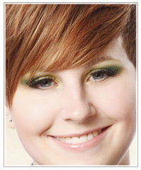 Model with red hair and green eye shadow