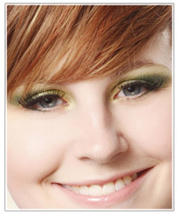 Model with brown hair and green eye shadow